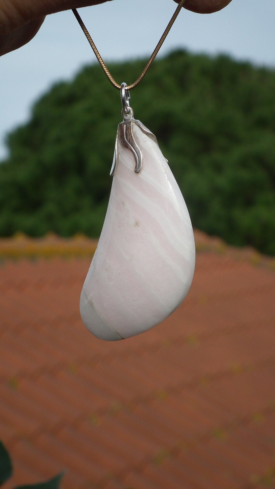 Mangano calcite pendant with silverplated